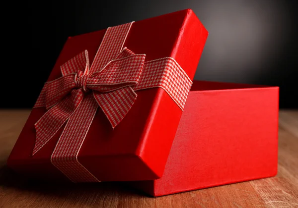 Open gift box on dark background — Stock Photo, Image