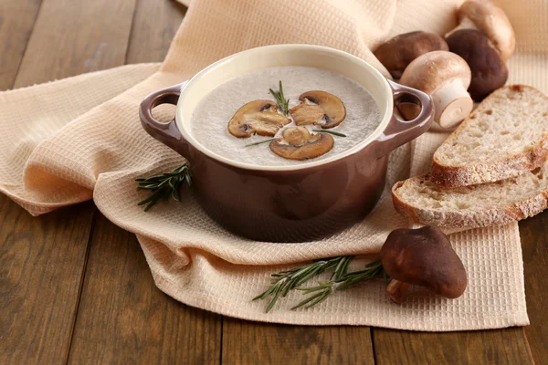 Mushroom soup in pot, on wooden background — Stock Photo, Image