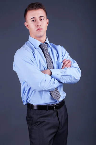 Handsome young man on gray background — Stock Photo, Image