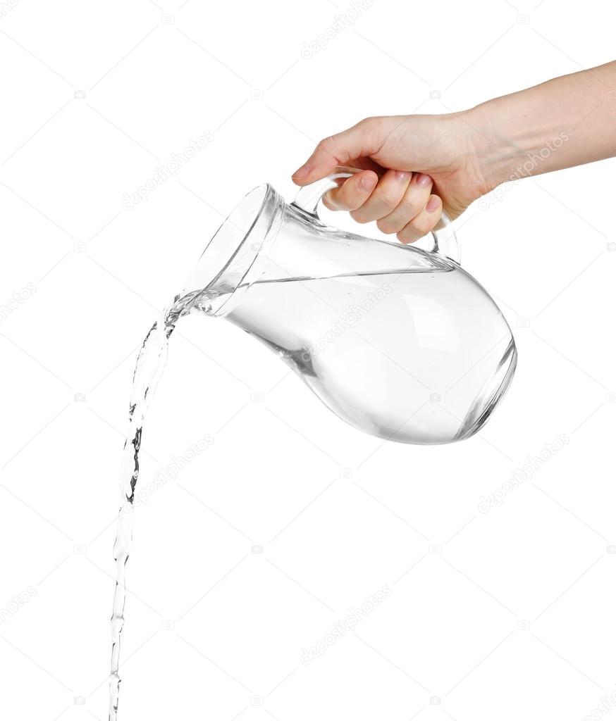 Pouring water from glass pitcher, isolated on white Stock Photo by