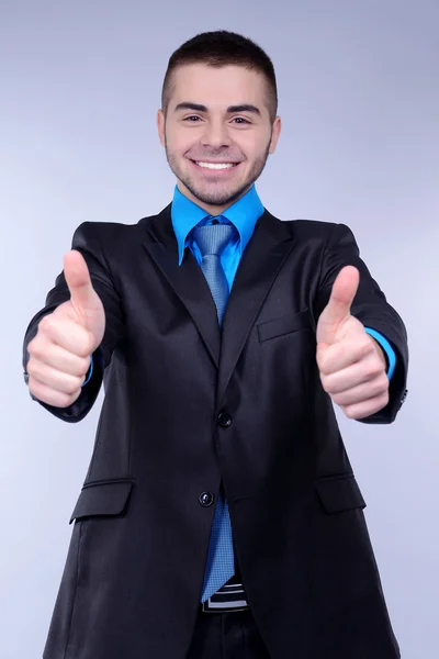 Business man on grey background — Stock Photo, Image