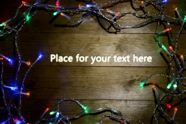 Luci di Natale su sfondo di legno — Foto Stock