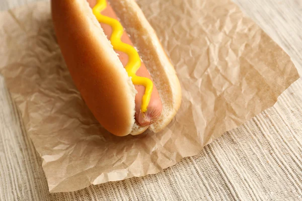 Tasty hot dog on paper — Stock Photo, Image