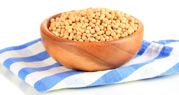 Raw soybeans in bowl on color napkin, isolated on white — Stock Photo, Image