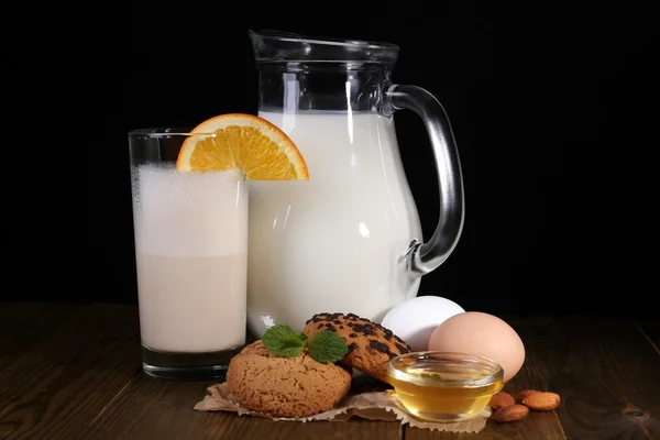 Eggnog with milk and eggs on table and black background — Stock Photo, Image