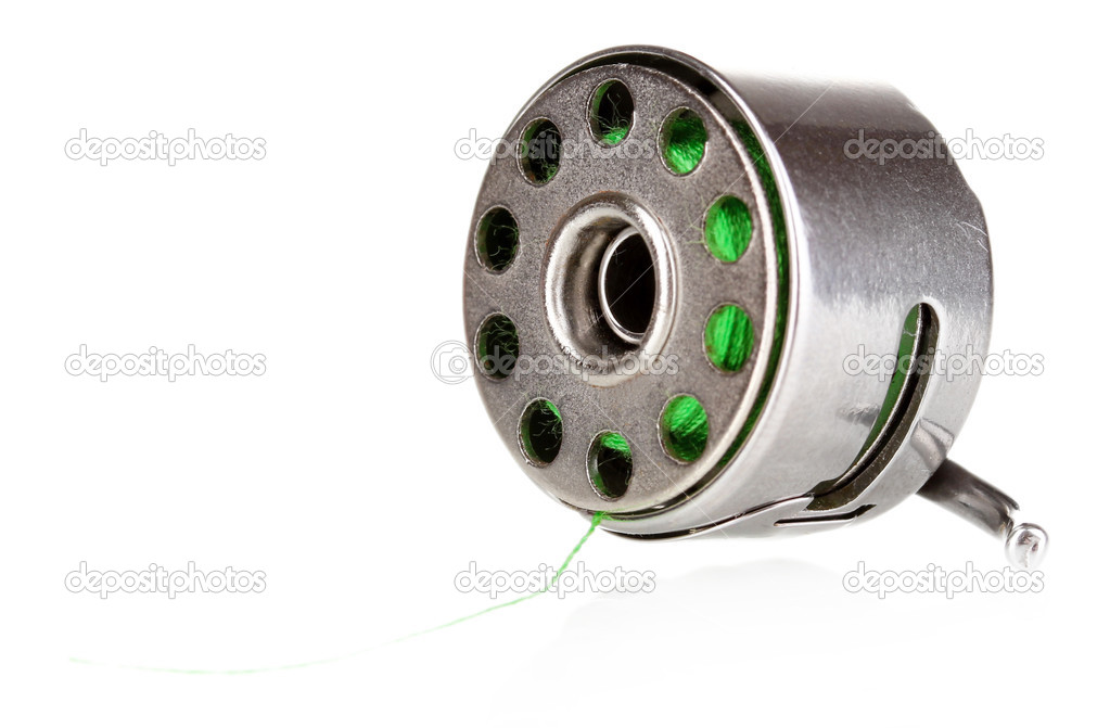 Metal spool of thread and sewing machine shuttle isolated on white