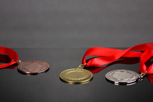 Three medals on grey background — Stock Photo, Image