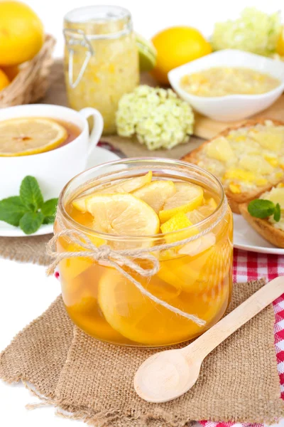 Leckere Zitronenmarmelade mit einer Tasse Tee auf dem Tisch in Großaufnahme — Stockfoto