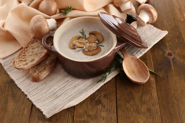 Mushroom soup in pot, on wooden background — Stock Photo, Image