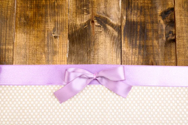 Colorful fabric with color ribbon and bow on wooden background — Stock Photo, Image