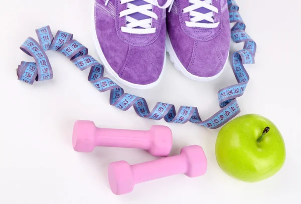 Sneakers and sport equipment. Conceptual photo of fitness progress. Isolated on white — Stock Photo, Image