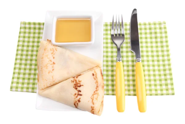 Fried pancakes on color plate, on color napkin, isolated on white — Stock Photo, Image