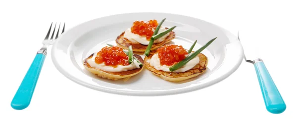 Pancakes with red caviar on plate, isolated on white — Stock Photo, Image