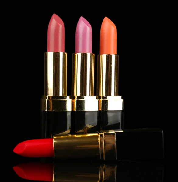 Beautiful lipsticks on black background — Stock Photo, Image