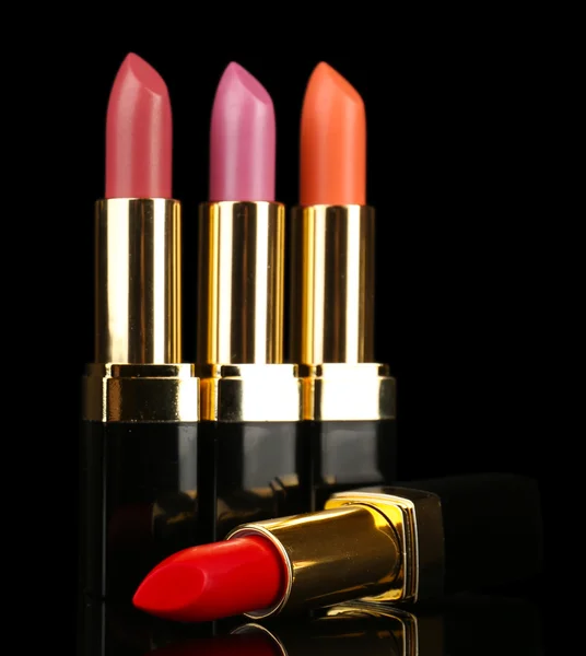 Beautiful lipsticks on black background — Stock Photo, Image