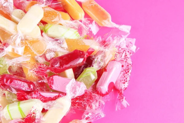 Tasty candies on pink background — Stock Photo, Image