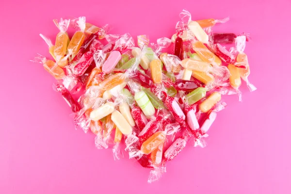 Tasty candies on pink background — Stock Photo, Image