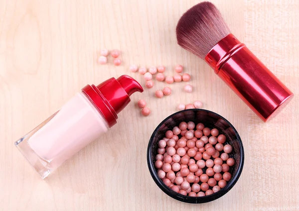 Composition with concealer, powder balls and brush on wooden background — Stock Photo, Image