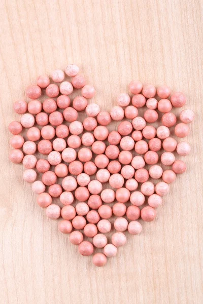 Powder balls on wooden background — Stock Photo, Image