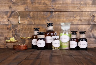 tarihi eski eczane şişeleri etiketli ve eski moda ağırlık ölçekler, ahşap arka plan üzerinde