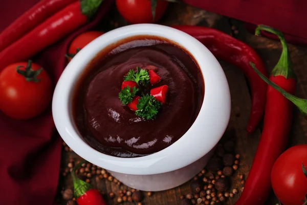 Tomato sauce in bowl on wooden table close-up — Stock Photo, Image