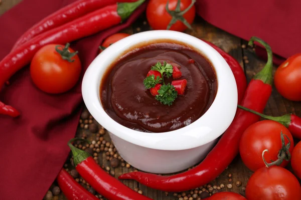 Tomato sauce in bowl on wooden table close-up — Stock Photo, Image