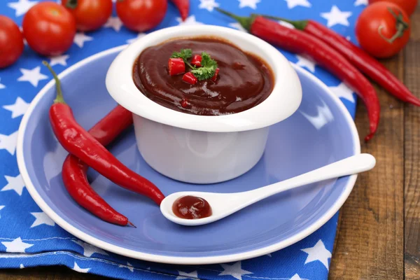 Tomato sauce in bowl on wooden table close-up — Stock Photo, Image