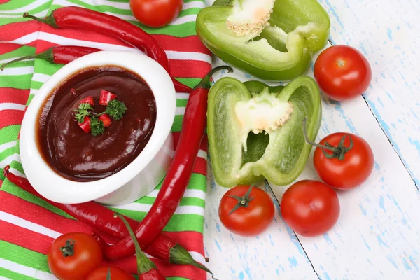 Tomato sauce in bowl on wooden table close-up — Stock Photo, Image