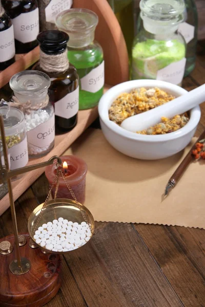 Composition with empty page, candle, mortar and historic old pharmacy bottles with label   on wooden background — Stock Photo, Image