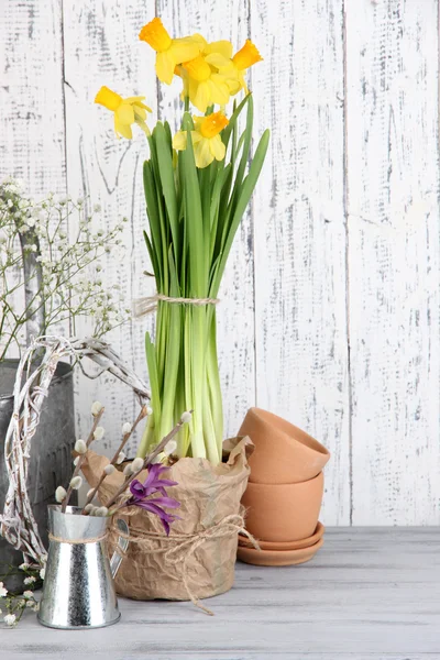 Beautiful spring flowers on old wooden background — Stock Photo, Image