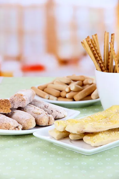 Variety of bread sticks on table, on bright background — Stock Photo, Image