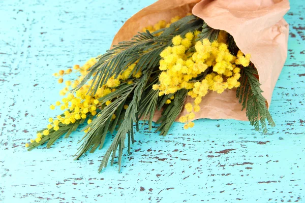 Twigs of mimosa flowers on old wooden table — Stock Photo, Image