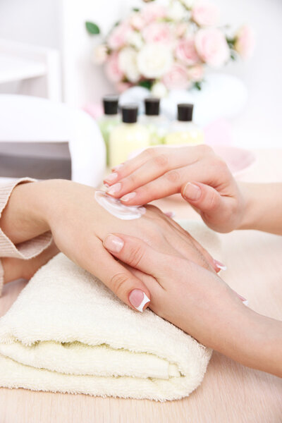 Manicure process in beauty salon close up