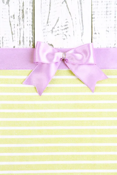 Colorful fabric with color ribbon and bow on wooden background — Stock Photo, Image