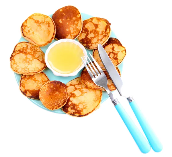 Fried pancakes on color plate, isolated on white — Stock Photo, Image