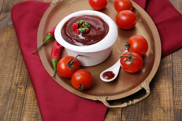 Tomato sauce in bowl on wooden table close-up — Stock Photo, Image