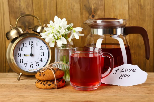 Tasty herbal tea and cookies on wooden table — Stock Photo, Image