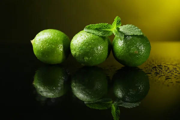 Fresh limes on dark background — Stock Photo, Image