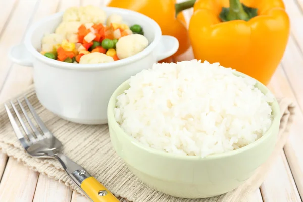 Cooked rice with vegetables on wooden table close up — Stock Photo, Image