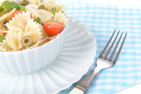 Delicious pasta with tomatoes on plate on table close-up — Stock Photo, Image