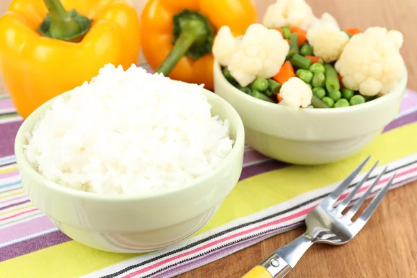 Cooked rice with vegetables on wooden table close up — Stock Photo, Image