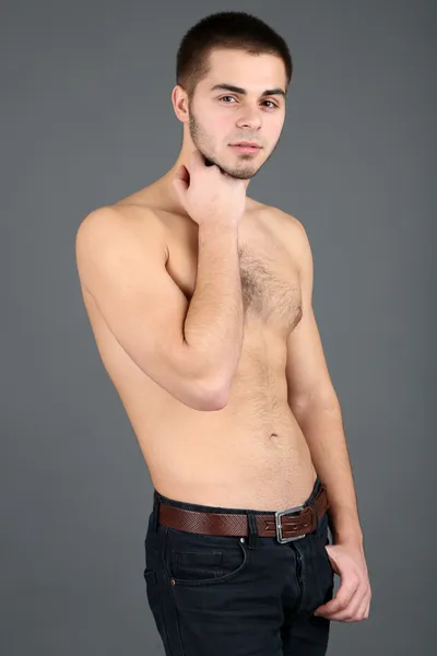 Handsome young man on gray background — Stock Photo, Image