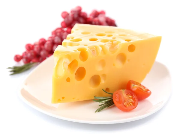 Piece of cheese with grape, tomato and rosemary on plate, isolated on white — Stock Photo, Image