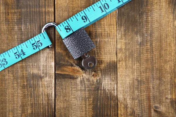 Conceptual photo of unlocking  secret of weight loss. On color wooden background — Stock Photo, Image