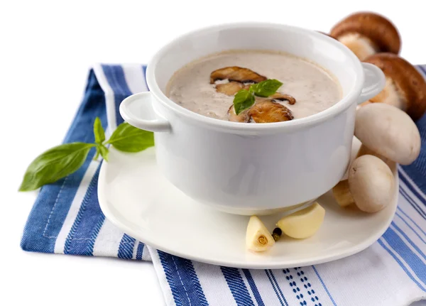 Mushroom soup in white pot, on napkin, isolated on white — Stock Photo, Image