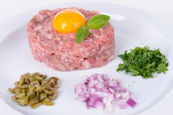 Delicious steak tartare with yolk on plate close-up — Stock Photo, Image