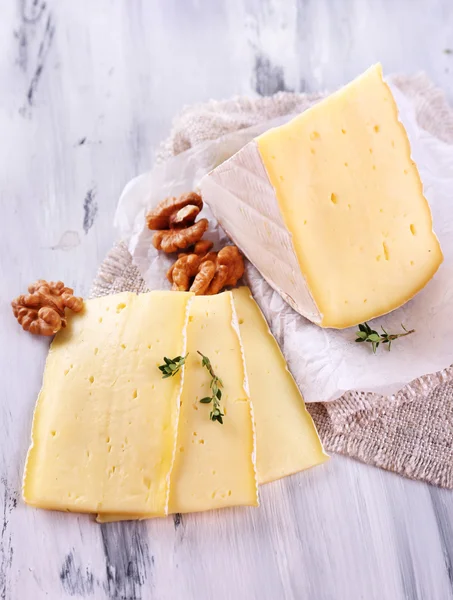 Smakelijke camembert kaas met noten, op houten tafel — Stockfoto