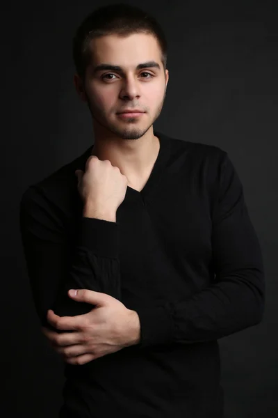 Handsome young man on dark background — Stock Photo, Image