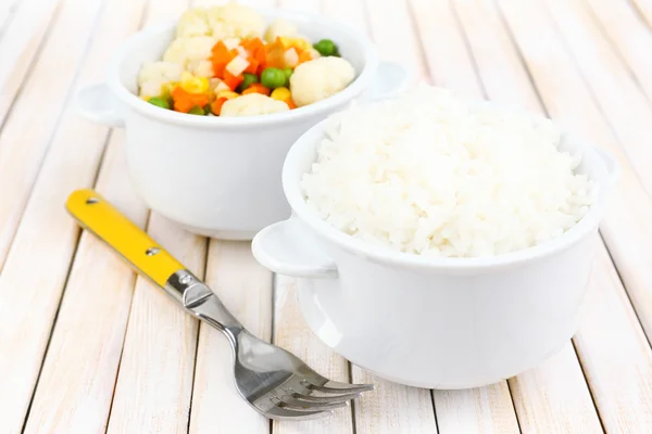 Cooked rice with vegetables on wooden table close up — Stock Photo, Image