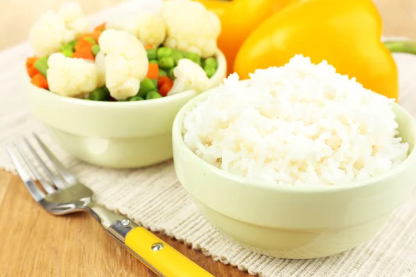 Cooked rice with vegetables on wooden table close up — Stock Photo, Image